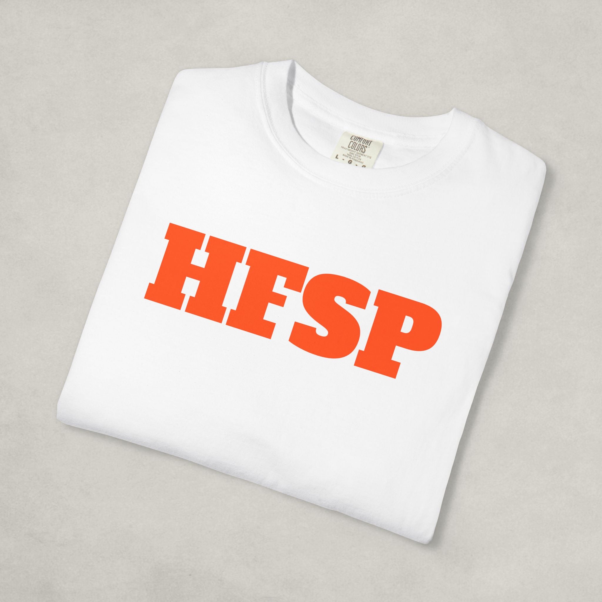 folded white t-shirt with red 'HFSP' text on a light gray background | The Orange Habit