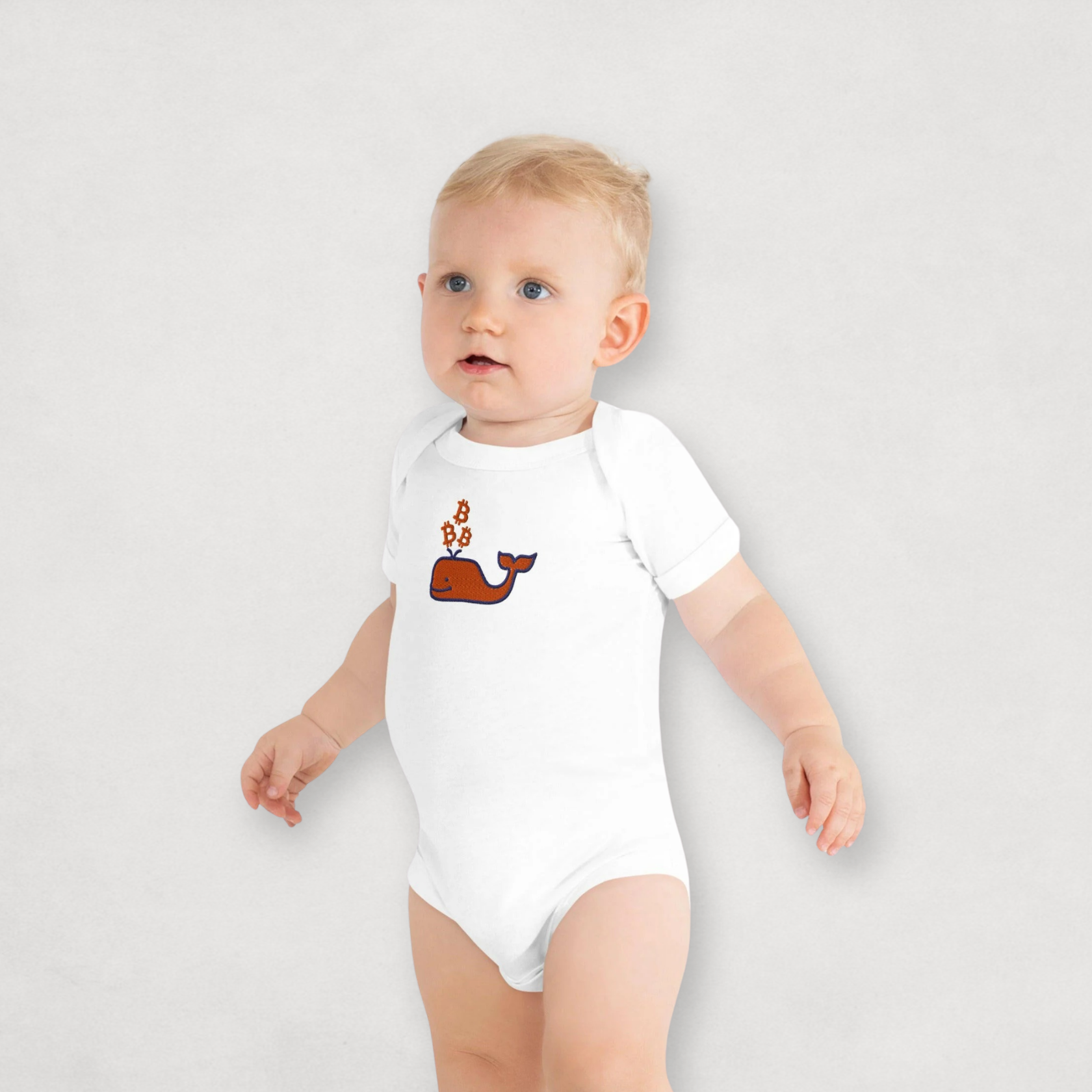 Baby boy wearing a white Bitcoin Onesie for Infants by the Bitcoin Whale Collection by lil'B