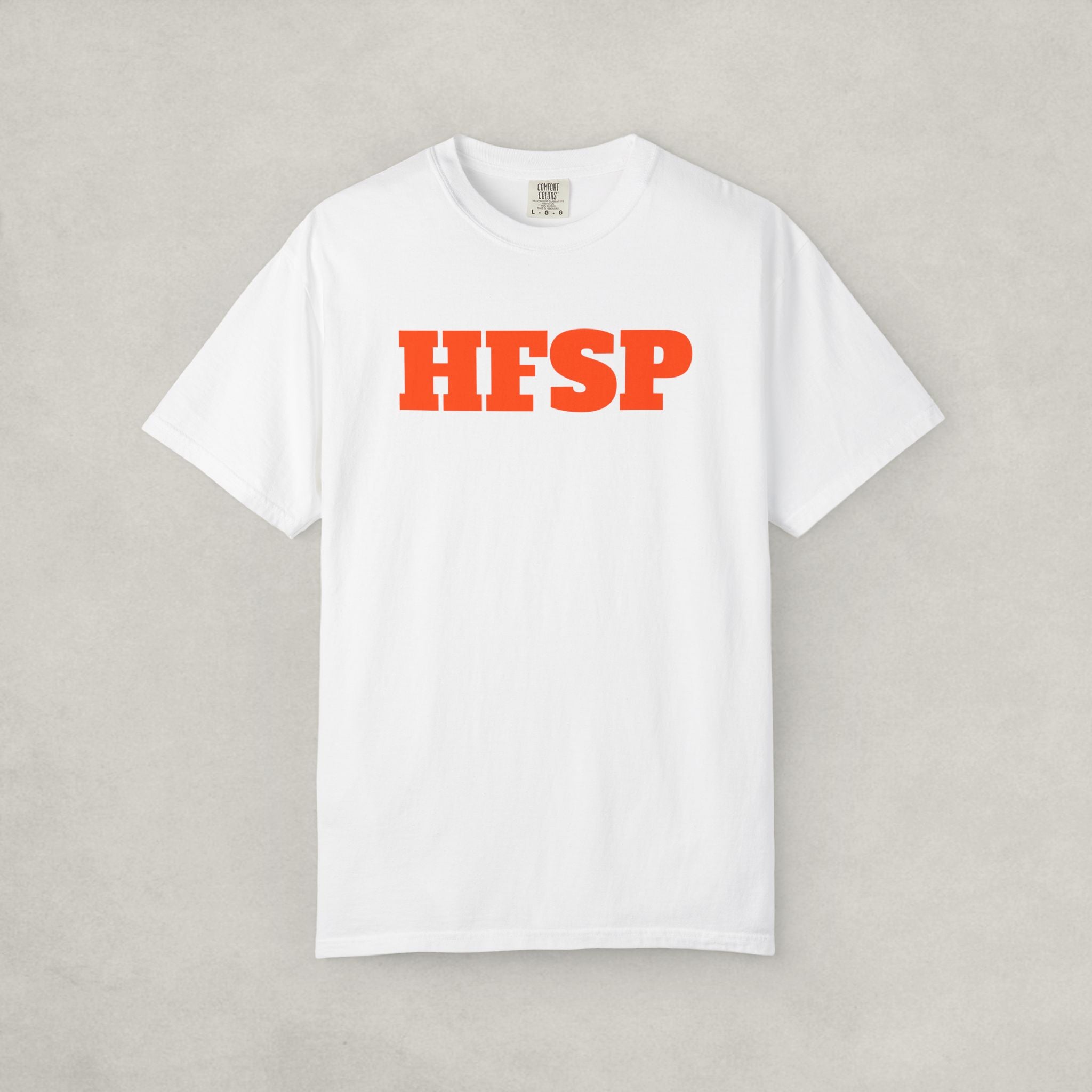 White t-shirt by SVRNT with 'HFSP' printed in orange on a light gray background | The Orange Habit