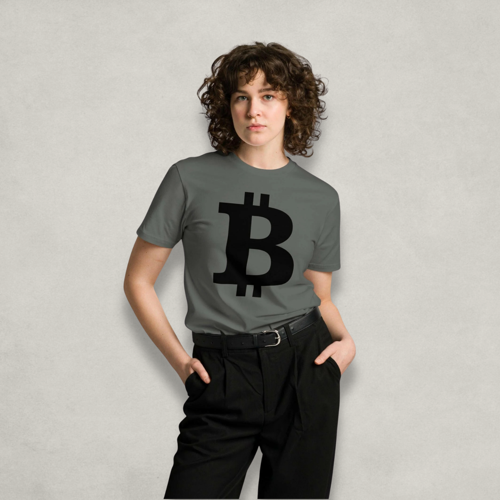 Woman wearing the Premium Bitcoin T-Shirt in grey with a large black bitcoin B on the front from The B Collection by Nikki Nakamoto
