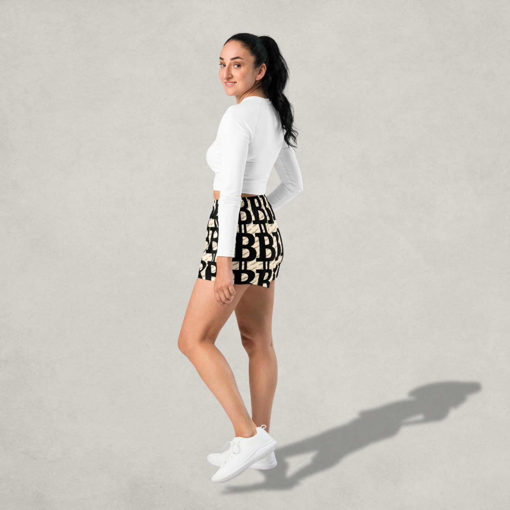 side view of a woman wearing Bitcoin Shorts from The B Collection by Nikki Nakamoto | The orange habit