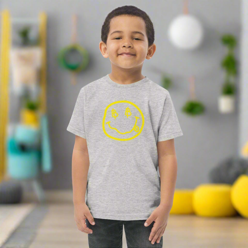 Boy standing and wearing a heather grey Satoshi Smiles kids Bitcoin Tee - Lil'B - The Orange Habit